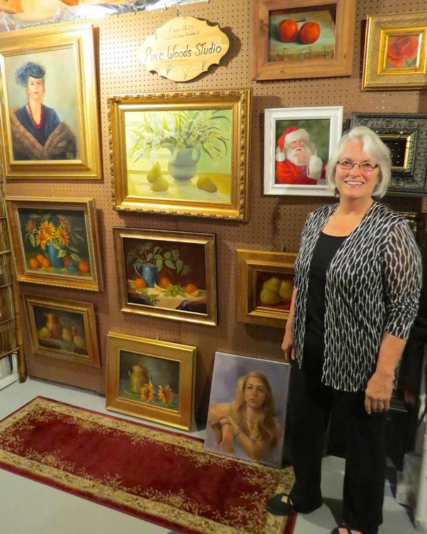 Linda Goddard with her paintings